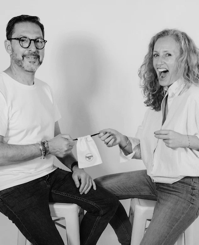 Two people sitting on chairs with a white background