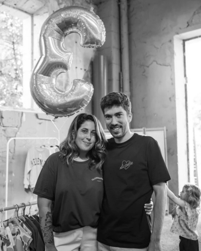 A black and white photo shows a man and a woman standing